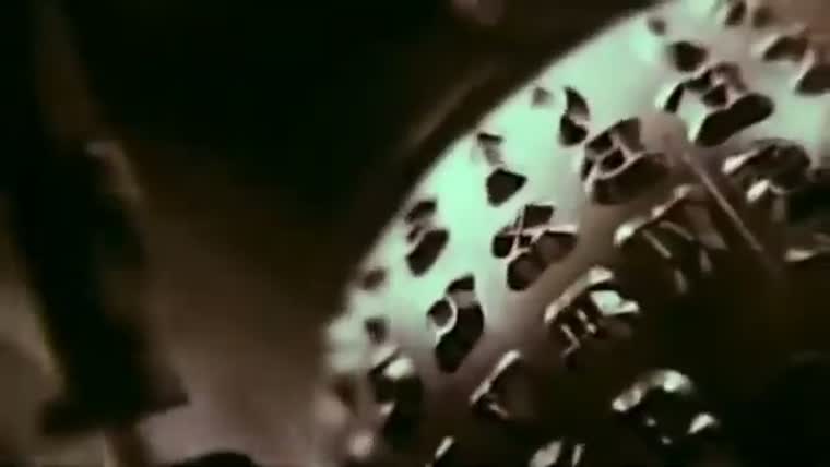Close-up of the type basket of an electric typewriter, keys and levers in shallow focus.